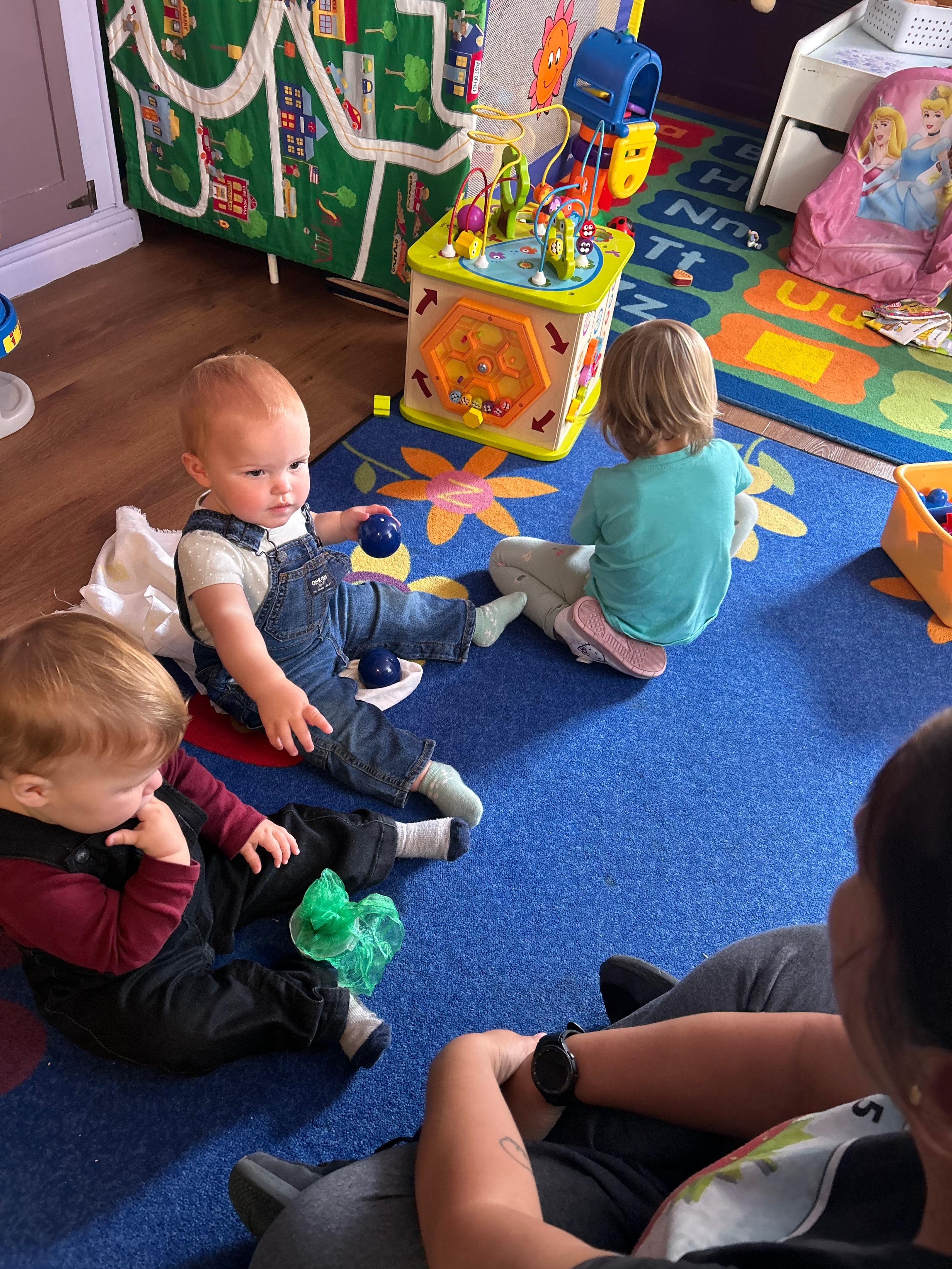 Toddlers playing mini golf outdoors