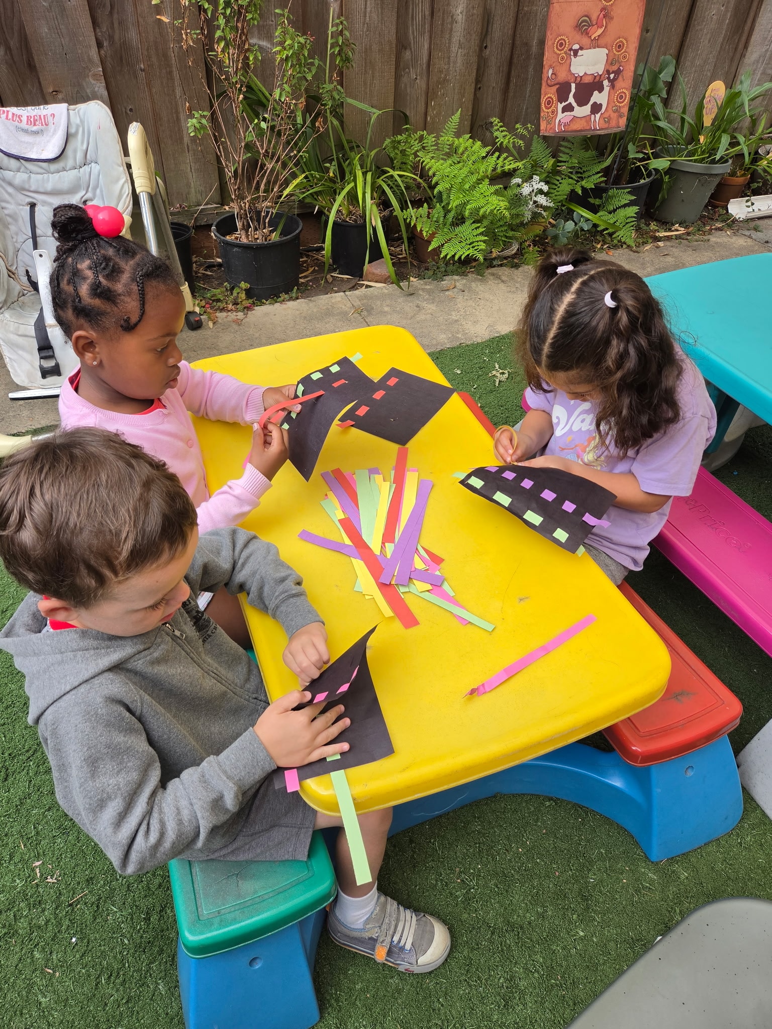 Toddler playing in water with caregiver outdoors